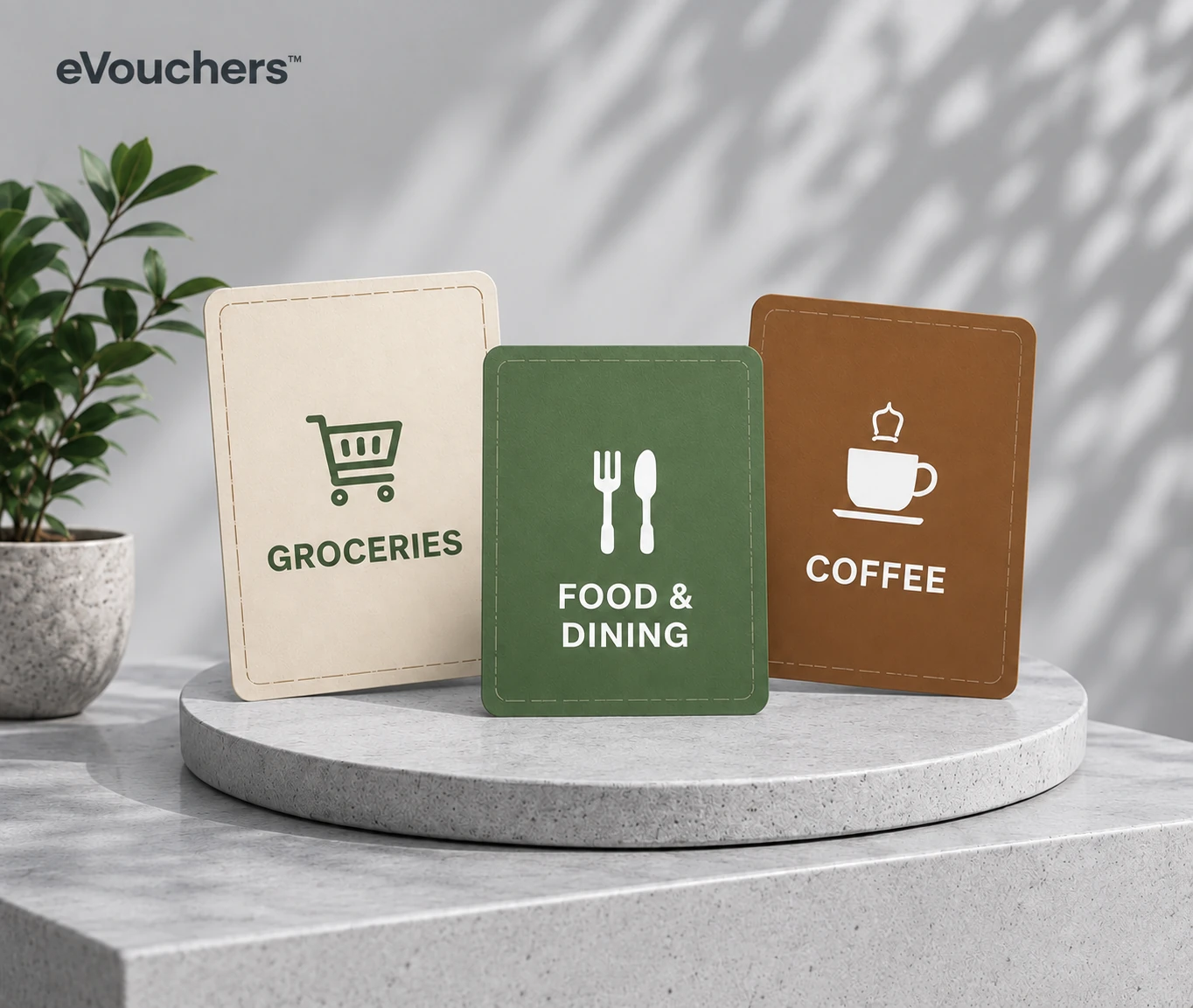 Groceries, food and dining, and coffee e-voucher cards on a stone plinth