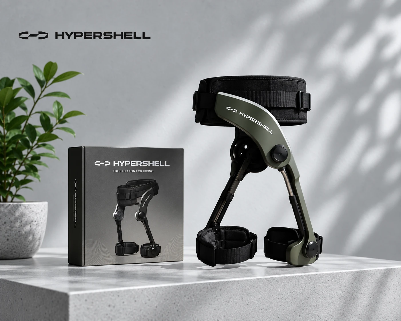Hypershell hiking exoskeleton beside its box on a stone ledge
