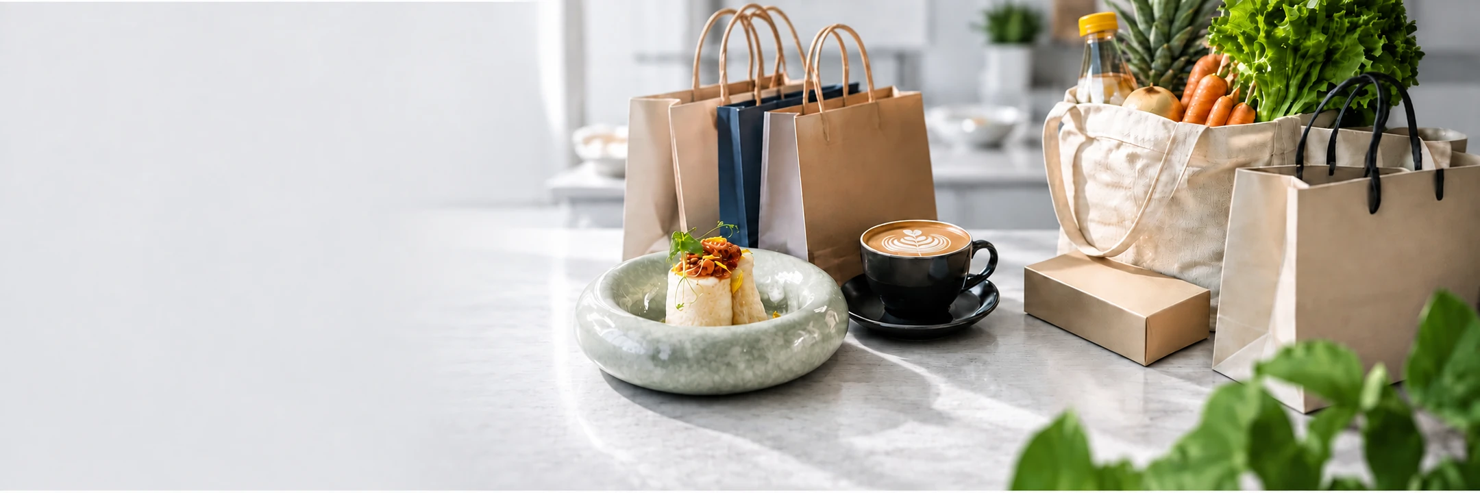 Shopping bags, groceries, plated food and coffee on a cool grey counter